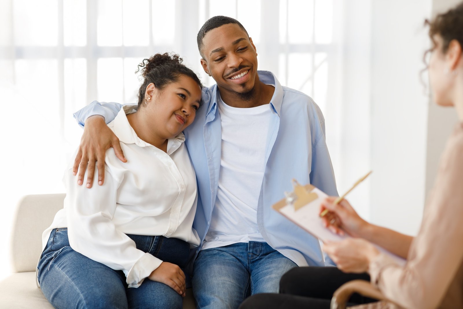 Cheerful african spouses attending therapy session together